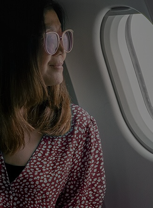 Woman looking out airplane window